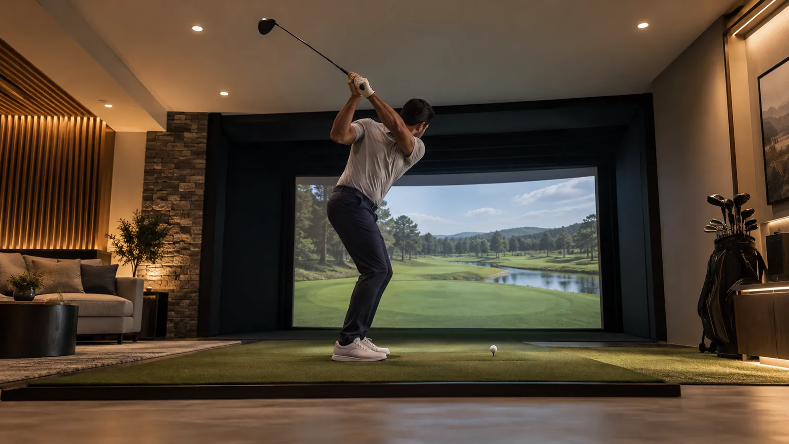Golfer at the top of a driver swing under a basement ceiling